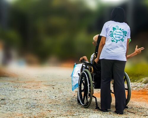 hospice-pushing-wheel-chair-disabled-elderly-handicap-nursing