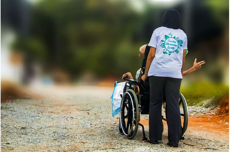 hospice-pushing-wheel-chair-disabled-elderly-handicap-nursing